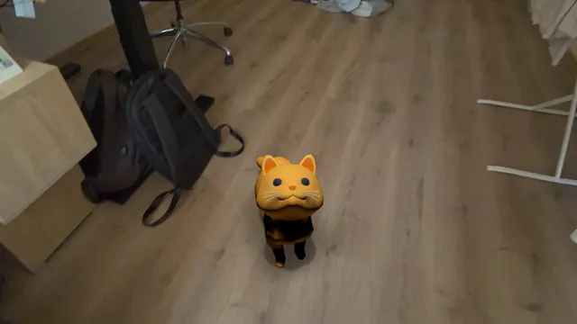 Tobby the orange tabby cat looking up at the player from a real wooden floor