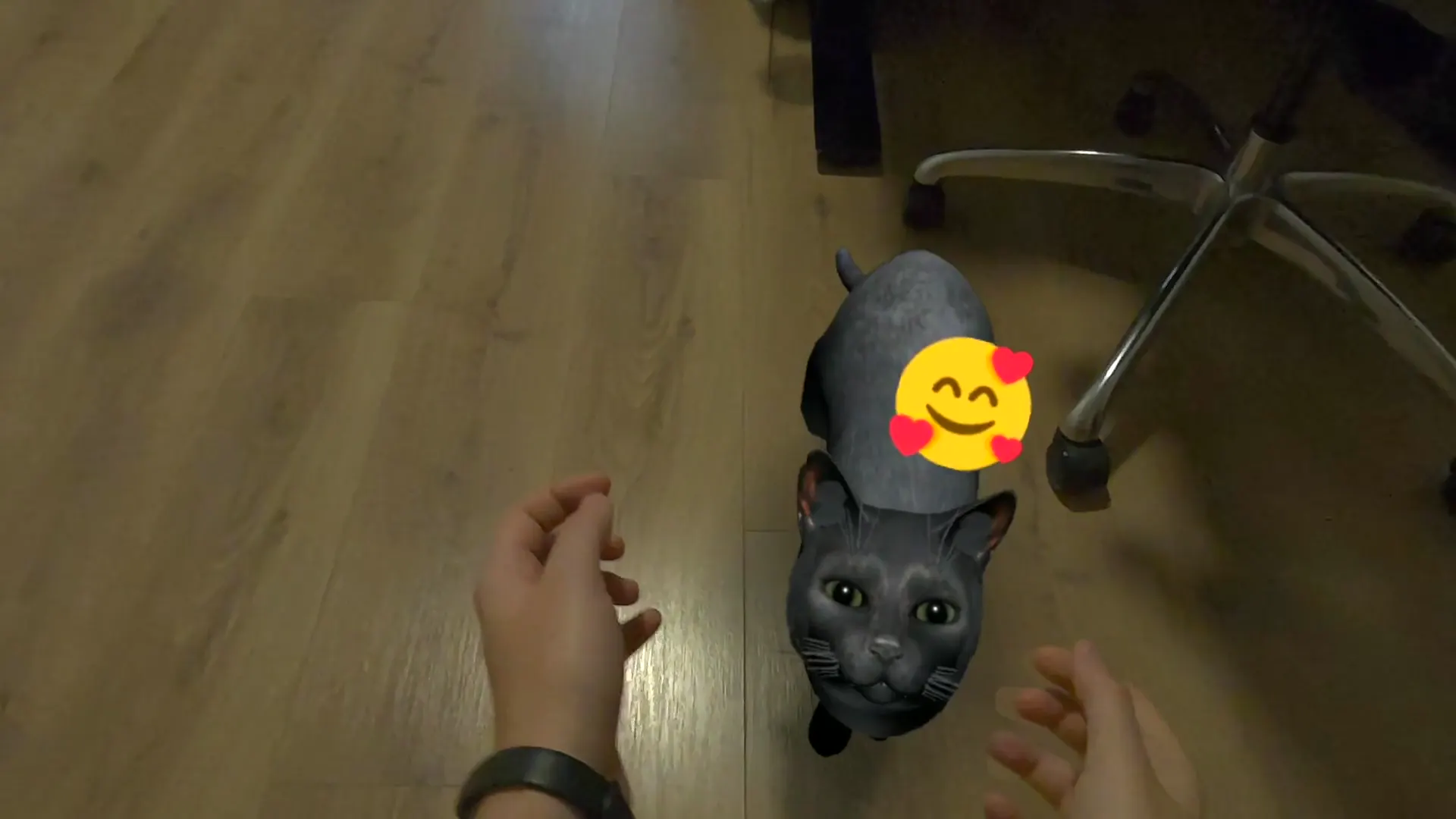 A black cat looks up between the player's hands, a happy face floating above it